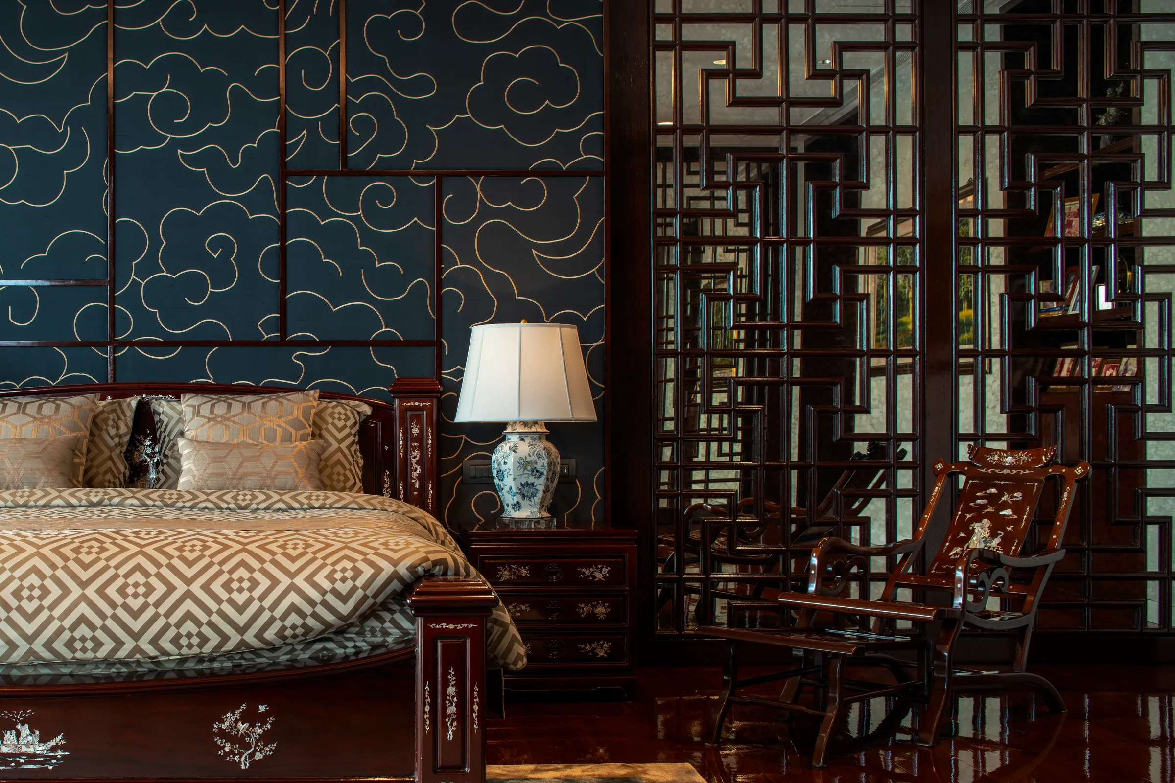 Bedroom 2 — indigo silk headboard with gold cloud embroidery.