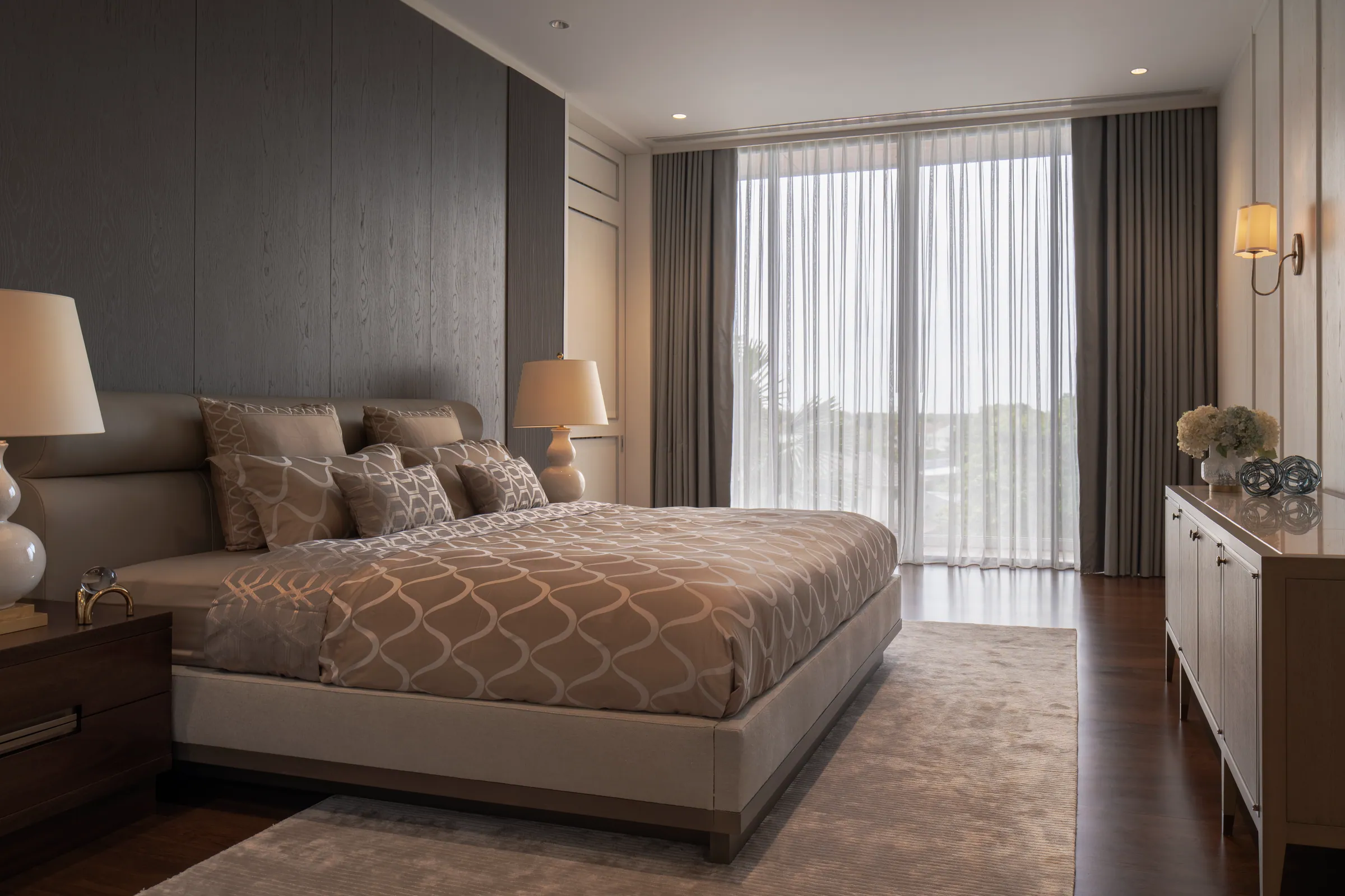 Bedroom 3 at Khon Kaen Residence — soft greige bed with geometric coverlet, modern minimal furnishing.