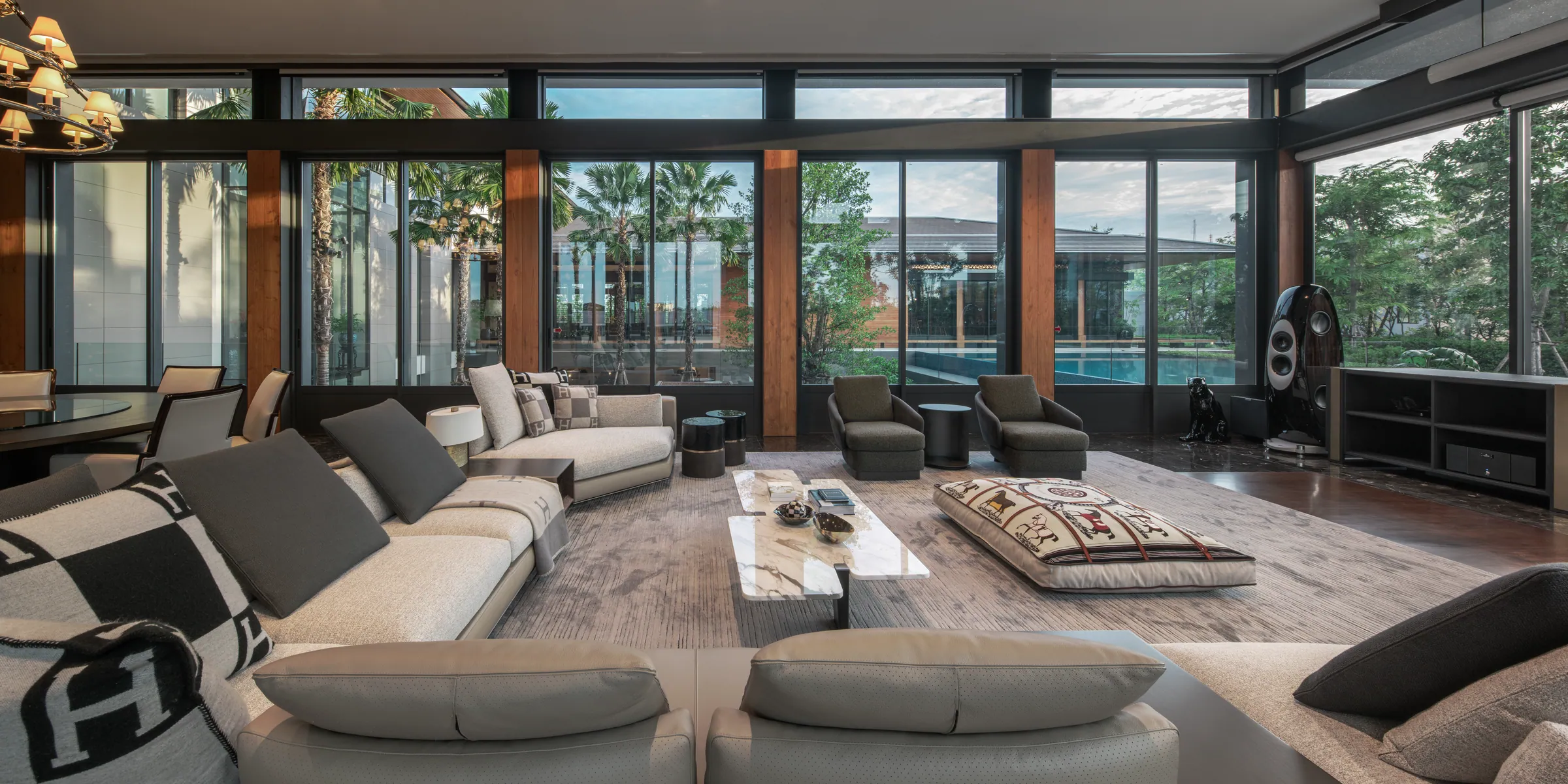 Living Room 3 — modern minimalist lounge with low-profile sectional and floor-to-ceiling glass.