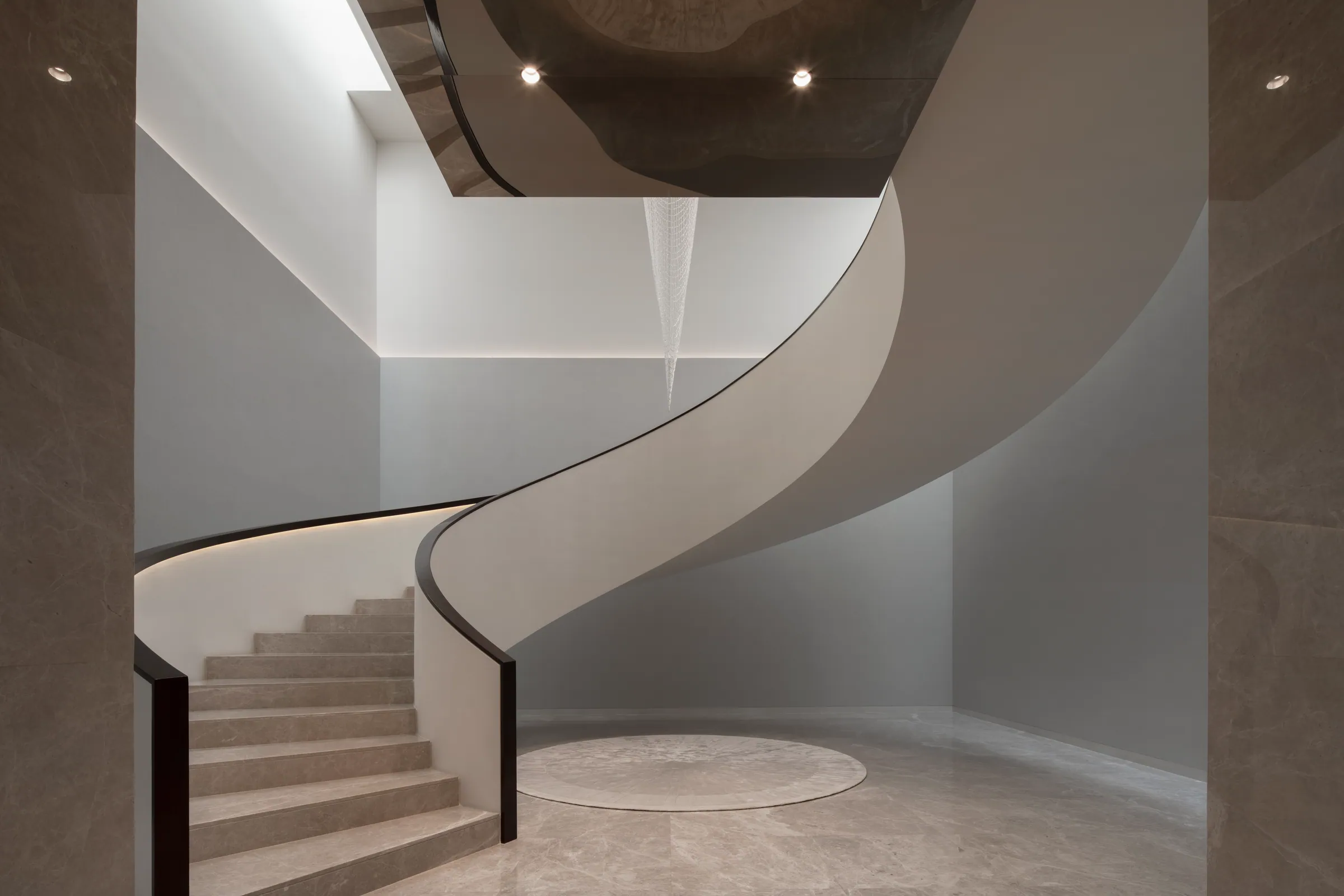 Mid-level view of the spiral staircase at Khon Kaen Residence.