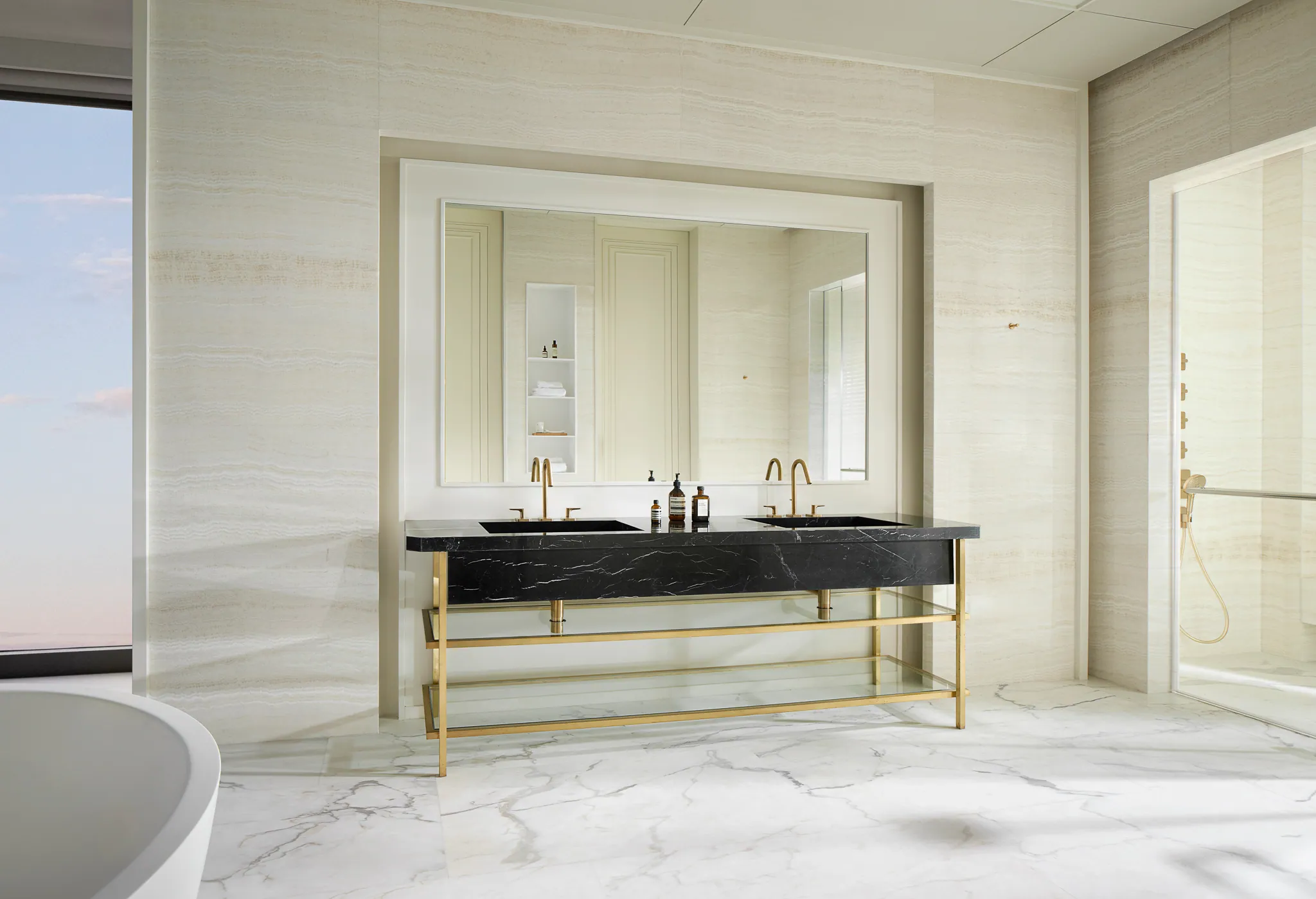 Day-mode bathroom at Black Box Project — marble, brass hardware, mirrored medicine wall, skyline view.