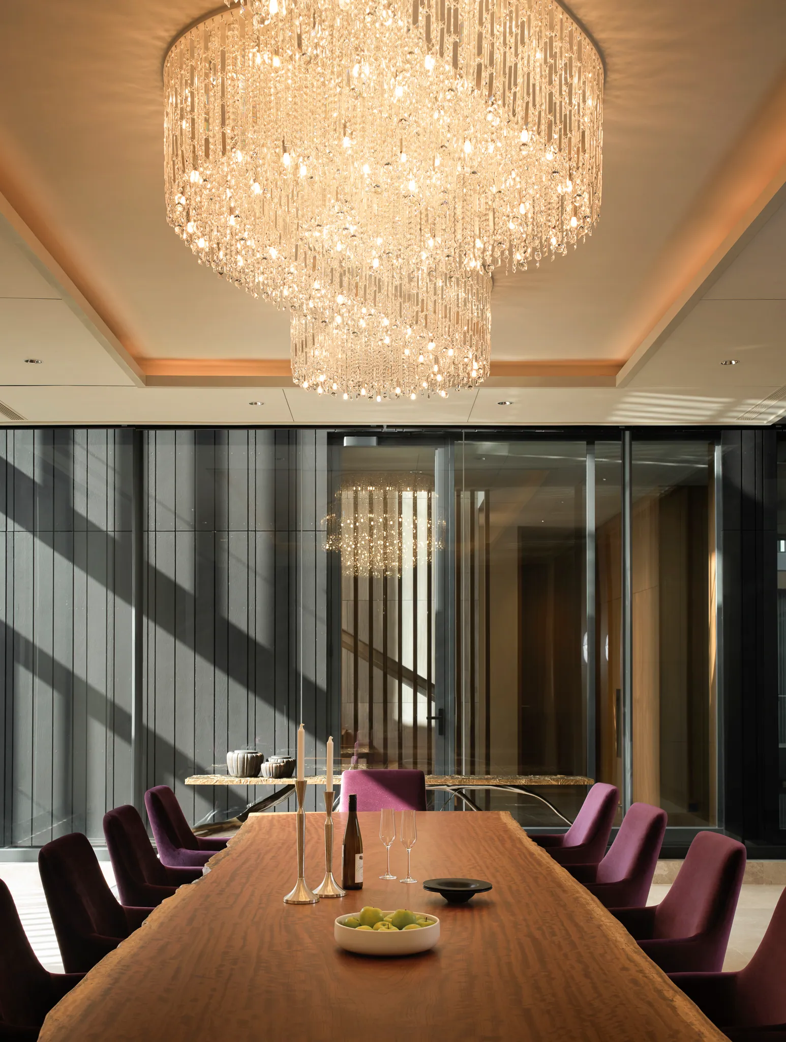 Meeting room at Black Box Project — crystal chandelier, purple velvet chairs, warm wood paneling.