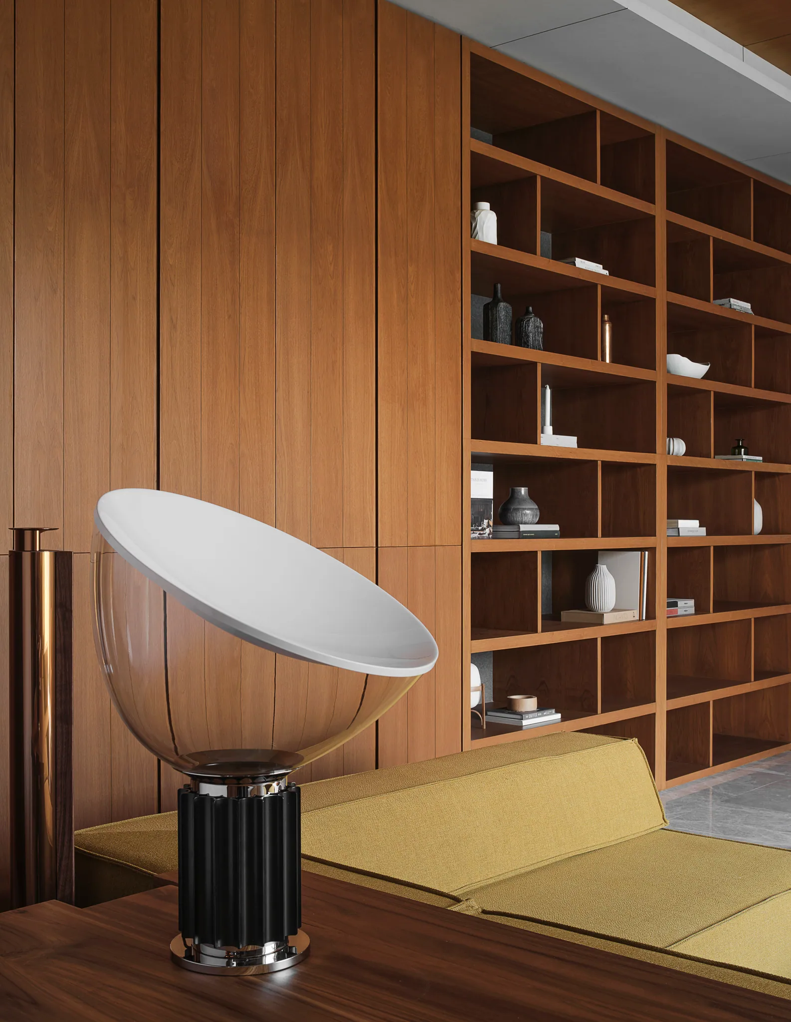 Netflix room at Black Box Project — warm wood library, sculptural white floor lamp, minimal seating cluster.