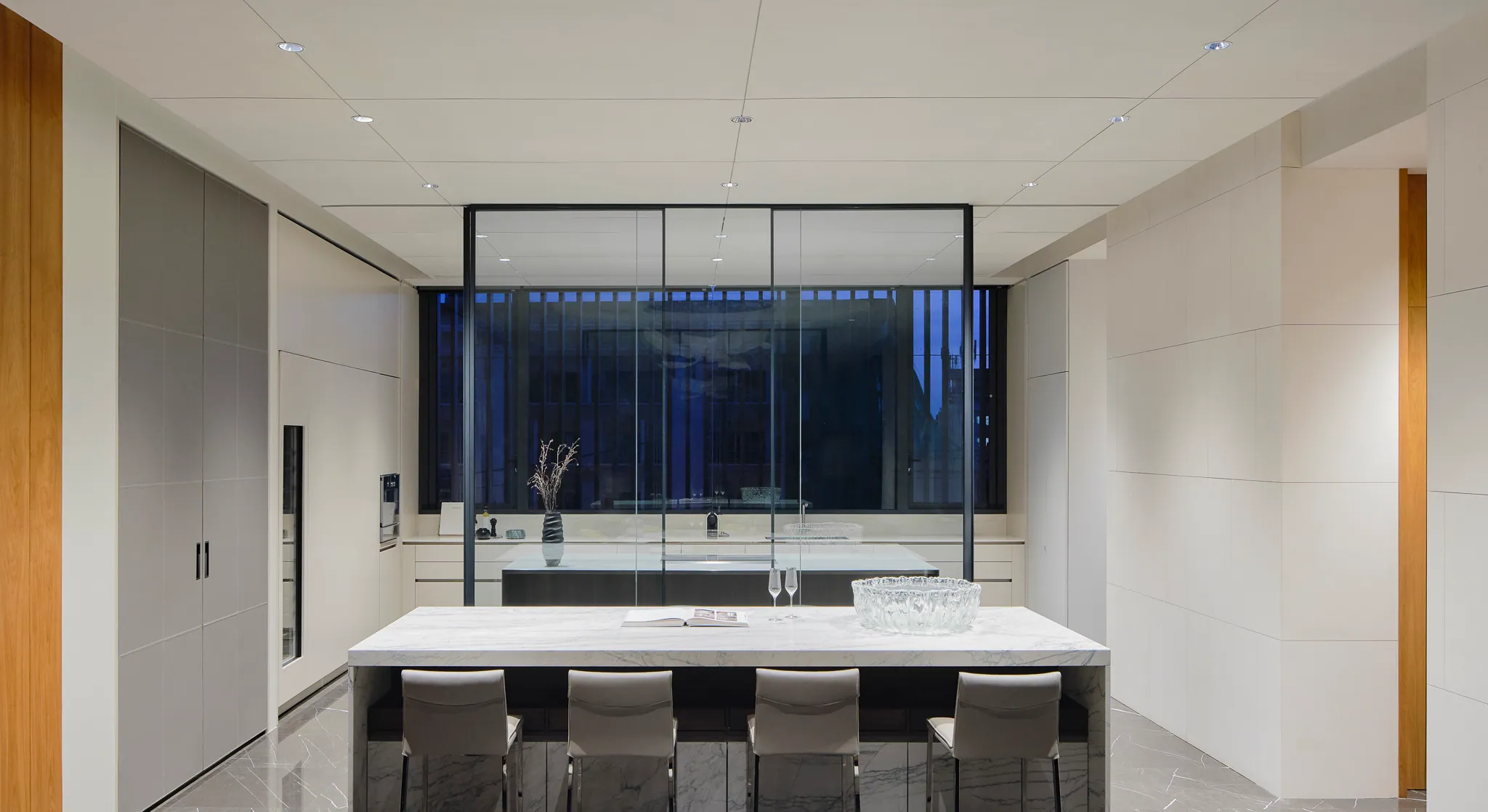 Pantry at Black Box Project — beige marble countertop, tall windows, minimalist fixtures.
