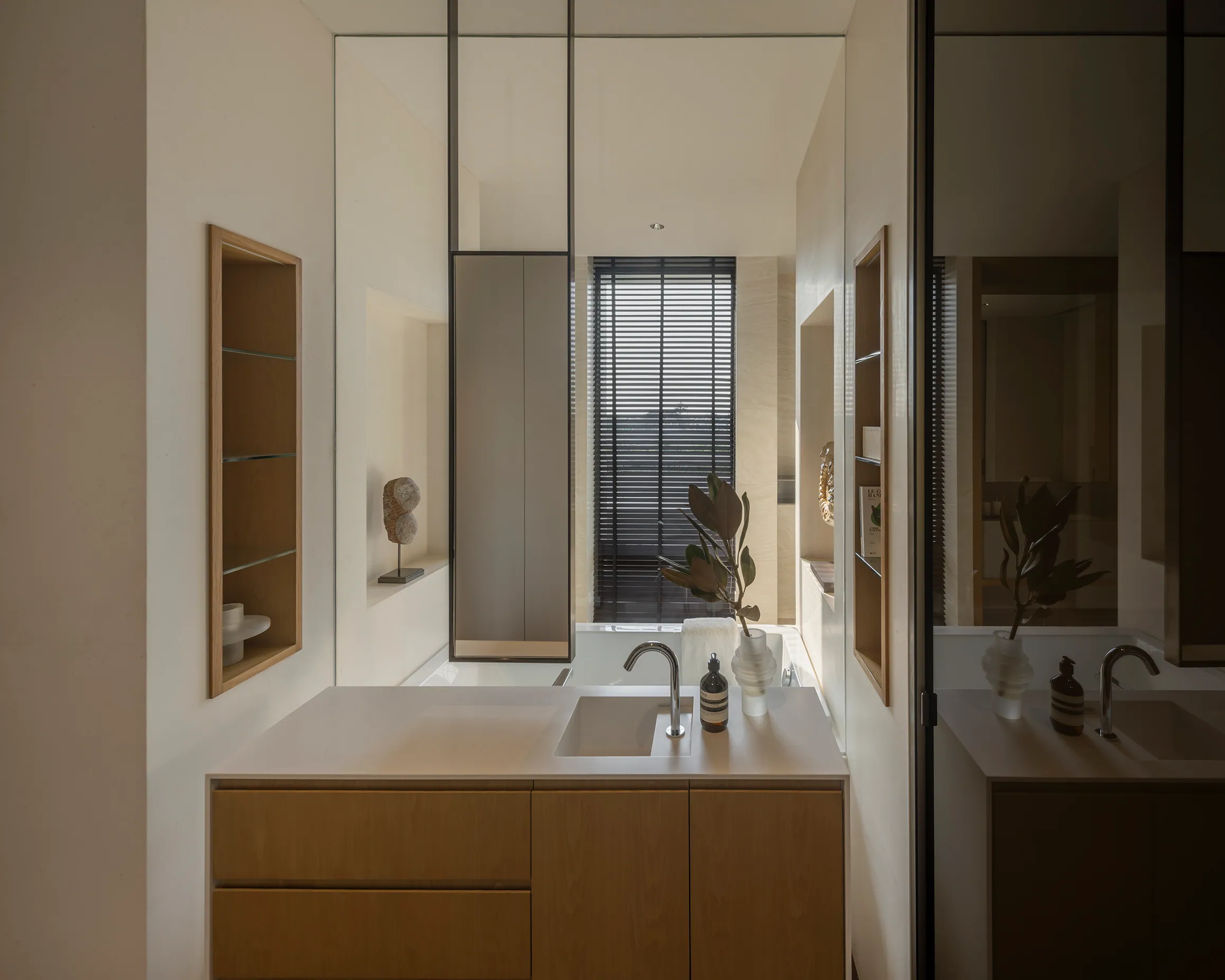 Secondary bedroom at Water House — wall-mounted bed, warm wood headwall, work nook.
